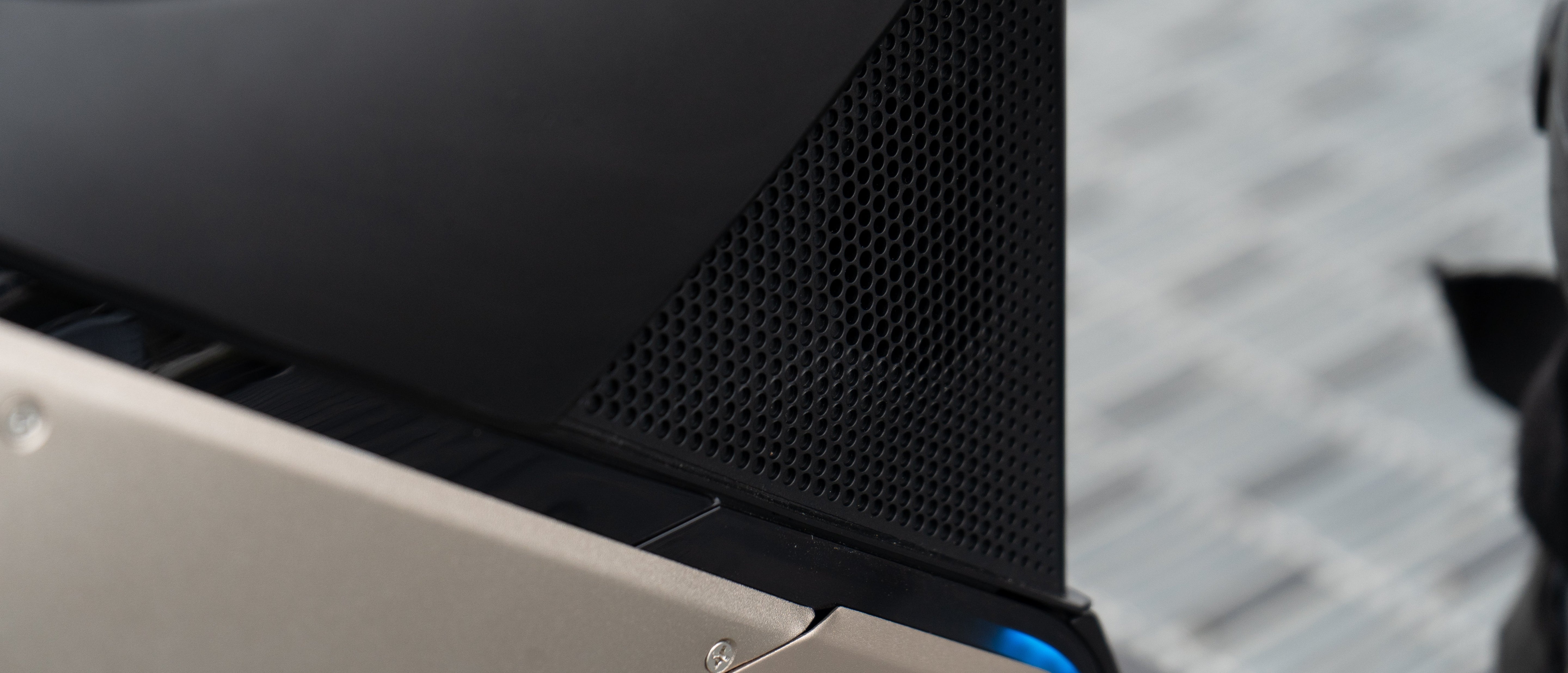 Close-up of a V12S side panel speaker with a textured background